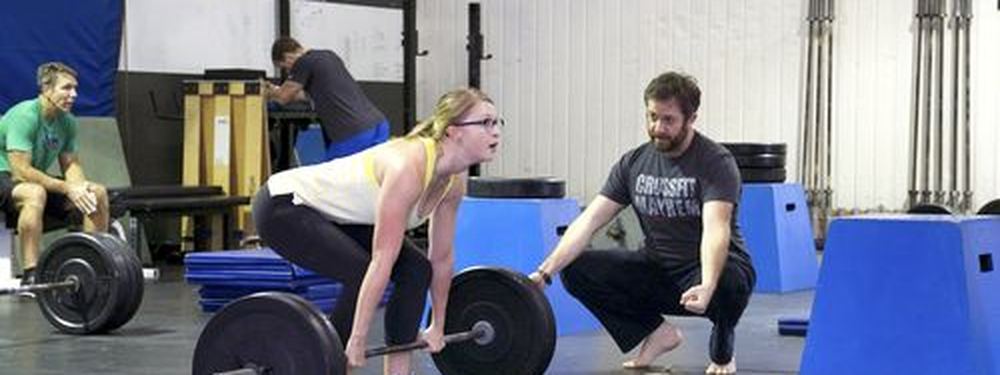 Coach spotting a deadlift