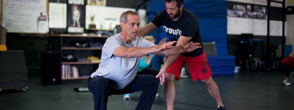 Coach correcting a squat