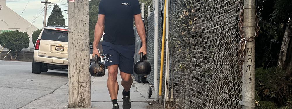 Coach walking in with kettlebells